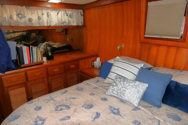 Slide: The Image of Cozy bedroom in 1986 Nova 36 Sundeck yacht with wood paneling and nautical-themed bedding. - 35