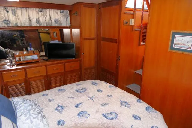 Slide: The Image of Cozy bedroom in 1986 Nova 36 Sundeck yacht with nautical decor and wooden cabinetry. - 38