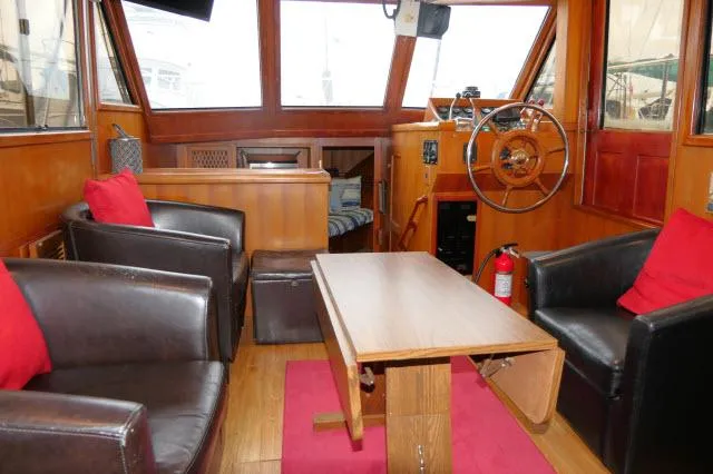 Slide: The Image of Interior of 1986 Nova 36 Sundeck yacht with leather chairs and wooden table. - 4