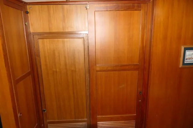 Slide: The Image of Wood-paneled interior of 1986 Nova 36 Sundeck yacht, featuring doors and framed artwork. - 40
