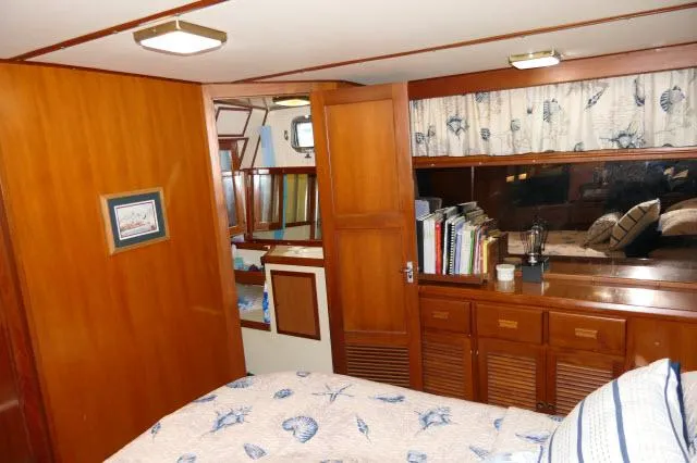 Slide: The Image of Interior of 1986 Nova 36 Sundeck yacht with wood paneling and cozy bedroom. - 42