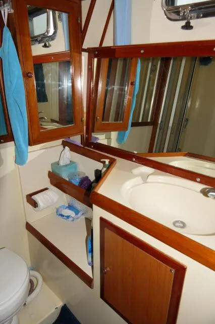 Slide: The Image of 1986 Nova 36 Sundeck bathroom with wooden cabinetry, sink, and mirror. - 43