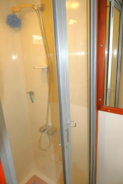 Slide: The Image of Shower area in 1986 Nova 36 Sundeck yacht with glass door and modern fixtures. - 44