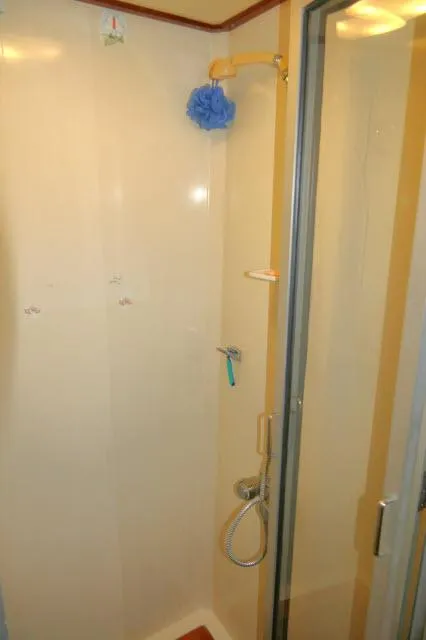 Slide: The Image of Shower area in 1986 Nova 36 Sundeck yacht, featuring a compact design. - 45