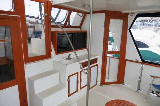 Slide: The Image of 1986 Nova 36 SUNDECK interior with stairs, sink, and windows. - 49