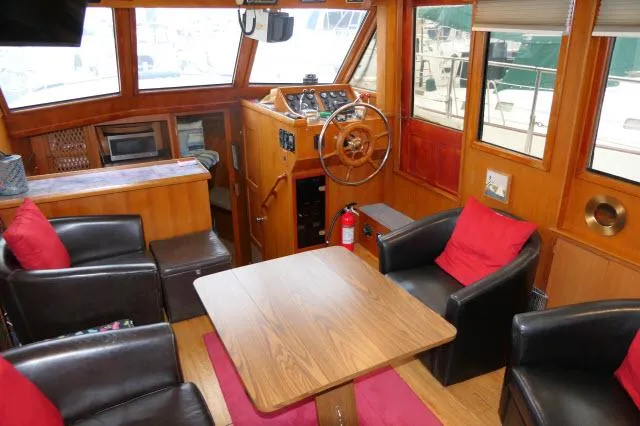 Slide: The Image of Interior of 1986 Nova 36 Sundeck yacht with seating, table, and helm. - 6
