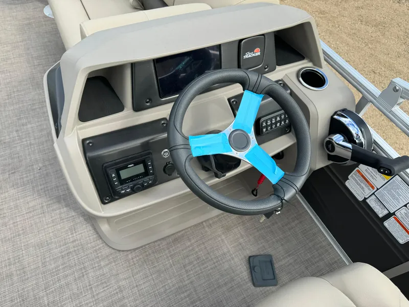 Slide: The Image of 2024 Sun Tracker Fishin' Barge 20 DLX steering console with modern controls and dashboard. - 17