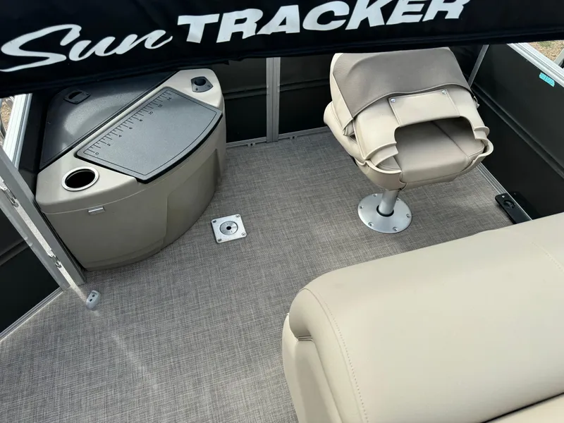Slide: The Image of 2024 Sun Tracker Fishin' Barge 20 DLX interior with seating and storage. - 18