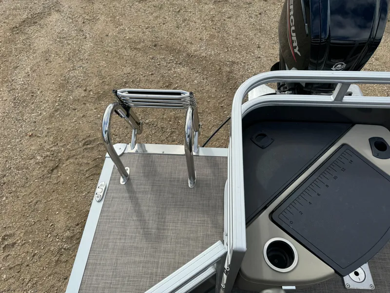 Slide: The Image of 2024 Sun Tracker Fishin' Barge 20 DLX boat deck with ladder and motor. - 19