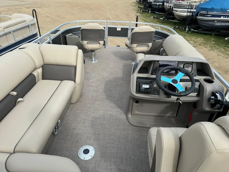 Slide: The Image of 2024 Sun Tracker Fishin' Barge 20 DLX interior with seating and steering console. - 22