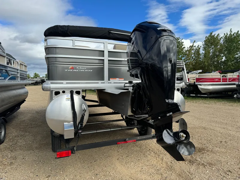 Slide: The Image of 2024 Sun Tracker Fishin' Barge 20 DLX pontoon boat with powerful outboard motor. - 4