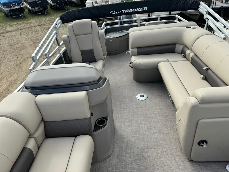 Slide: The Image of 2024 Sun Tracker Fishin' Barge 20 DLX interior with plush seating and spacious layout. - 7