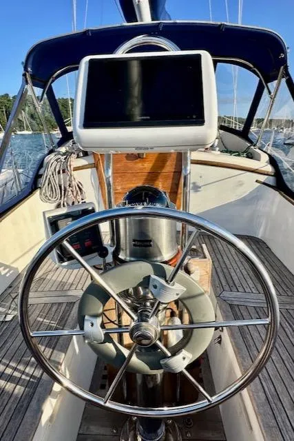 Slide: The Image of 1986 Mason 33 sailboat helm with steering wheel and navigation equipment. - 16