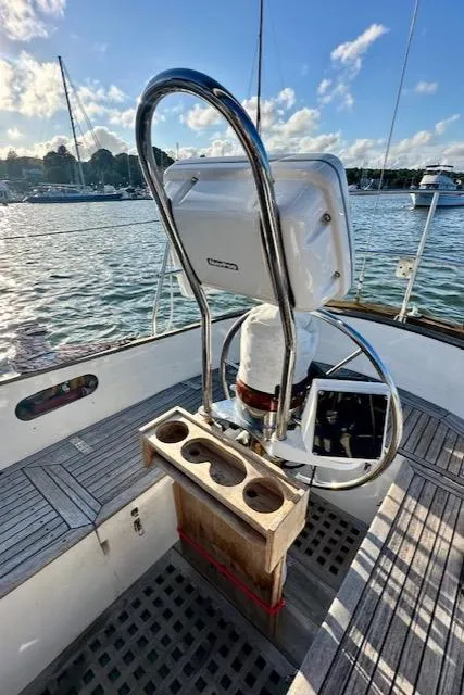 Slide: The Image of Sailboat cockpit with steering wheel, Mason 33, 1986 model, docked in a marina. - 17