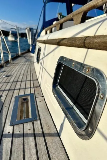 Slide: The Image of Close-up of 1986 Mason 33 sailboat deck with porthole and railing. - 18