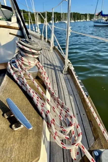 Slide: The Image of Sailboat deck with ropes, Mason 33, 1986 model, moored on calm water. - 19