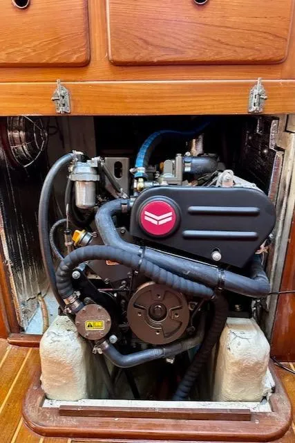 Slide: The Image of 1986 Mason 33 engine compartment with visible components and wooden cabinetry. - 22