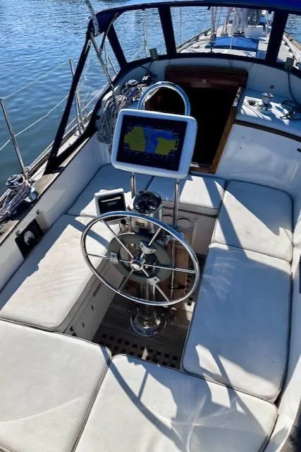 Slide: The Image of 1986 Mason 33 sailboat cockpit with steering wheel and navigation system. - 23