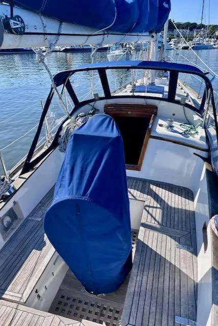 Slide: The Image of 1986 Mason 33 sailboat cockpit with blue covers, docked in a marina. - 24