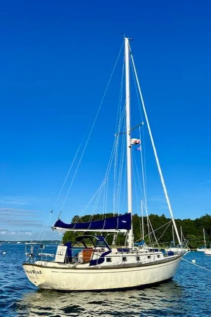 Slide: The Image of 1986 Mason 33 sailboat on calm water under clear blue sky. - 7