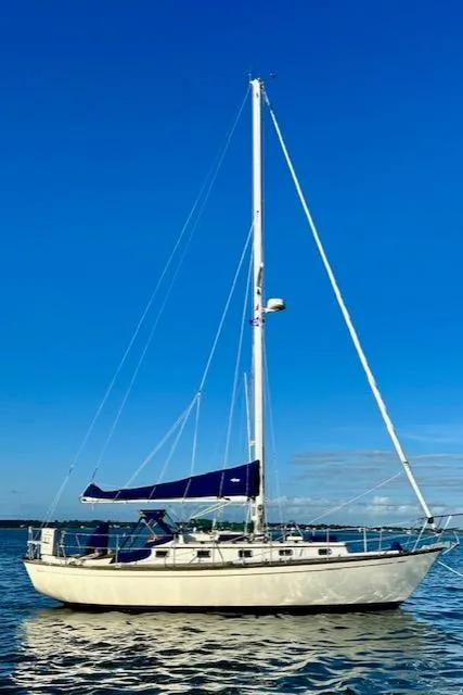 Slide: The Image of 1986 Mason 33 sailboat on calm water under clear blue sky. - 8