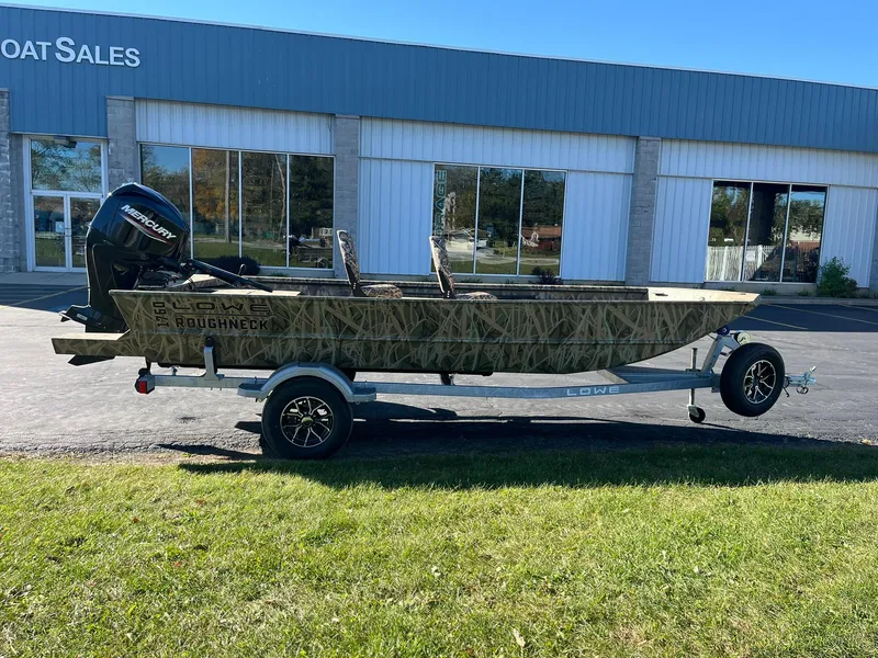Slide: The Image of 2025 Lowe Roughneck 1760 boat on trailer outside dealership. - 1