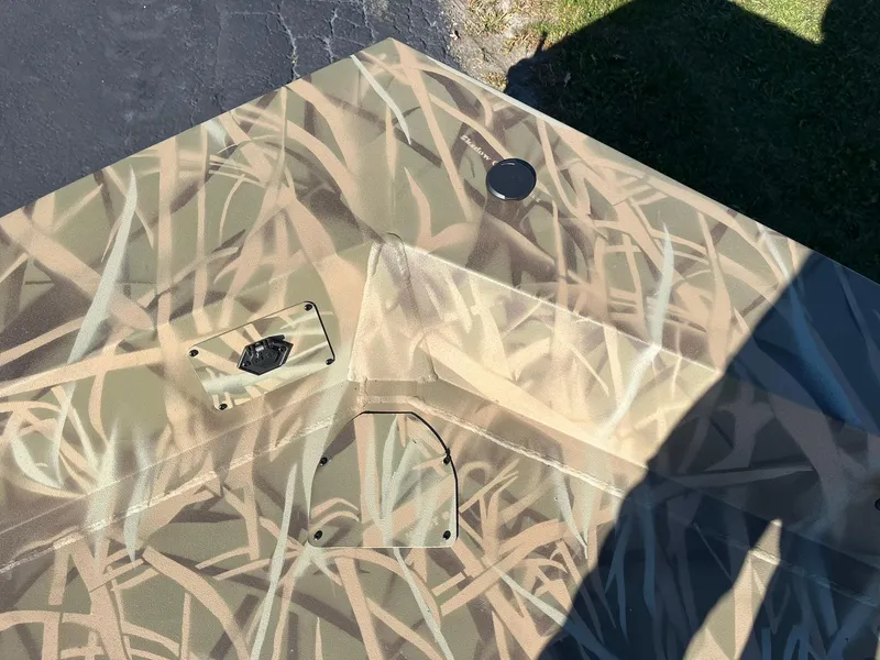 Slide: The Image of 2025 Lowe Roughneck 1760 boat with camouflage pattern on deck. - 17