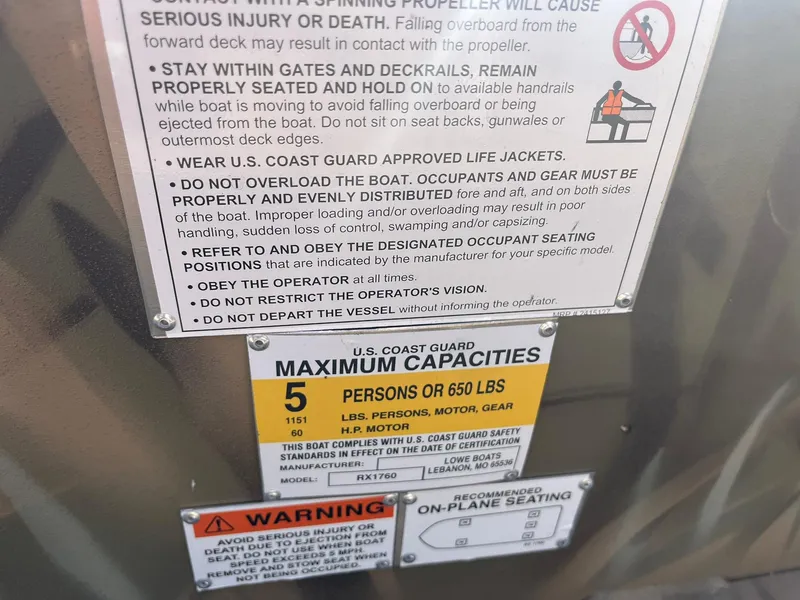 Slide: The Image of Safety and capacity labels on a 2025 Lowe Roughneck 1760 boat. - 23