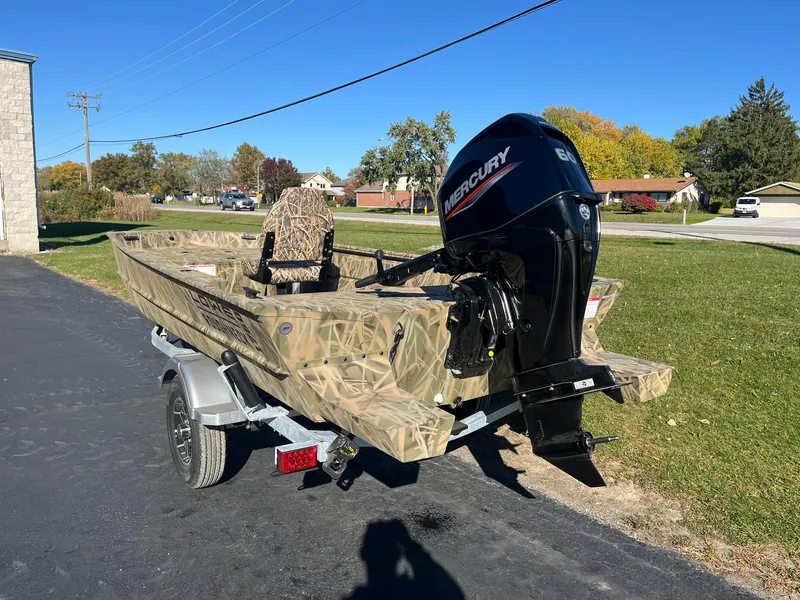 Slide: The Image of 2025 Lowe Roughneck 1760 boat with Mercury engine on trailer, parked outdoors. - 4