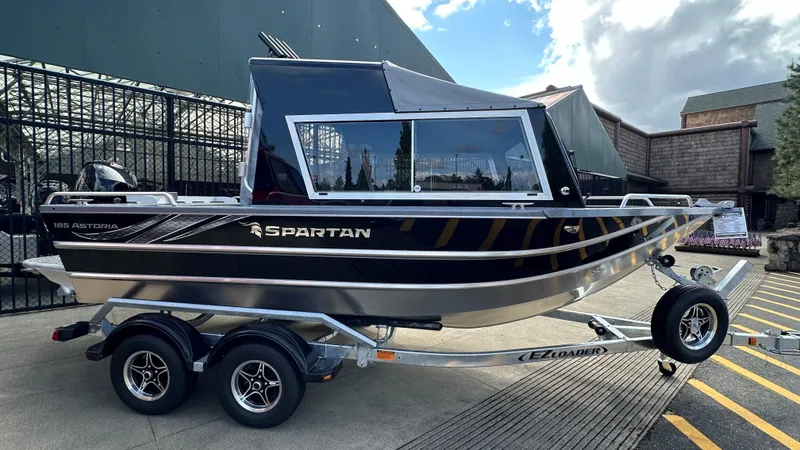 The Image of 2024 Spartan 184 ASTORIA boat on trailer, sleek design, black and silver finish. - 0