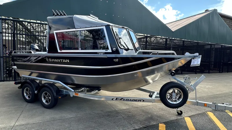 Slide: The Image of 2024 Spartan 184 ASTORIA boat on trailer, sleek design, parked outdoors. - 1