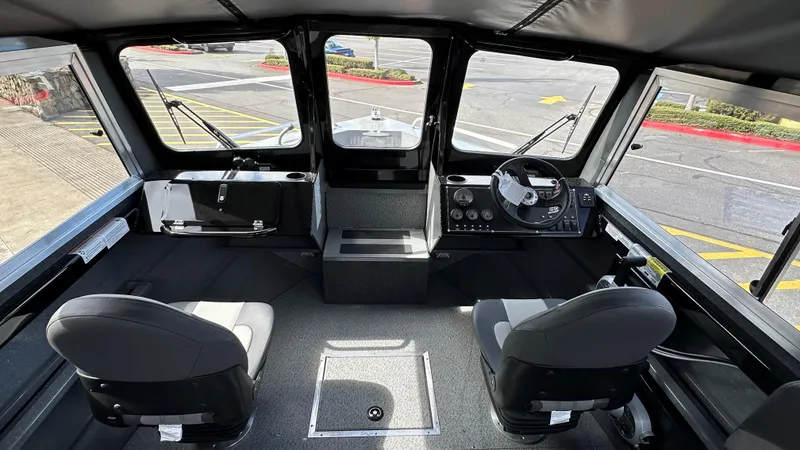 Slide: The Image of 2024 Spartan 184 ASTORIA boat interior with dual seats and modern dashboard. - 2