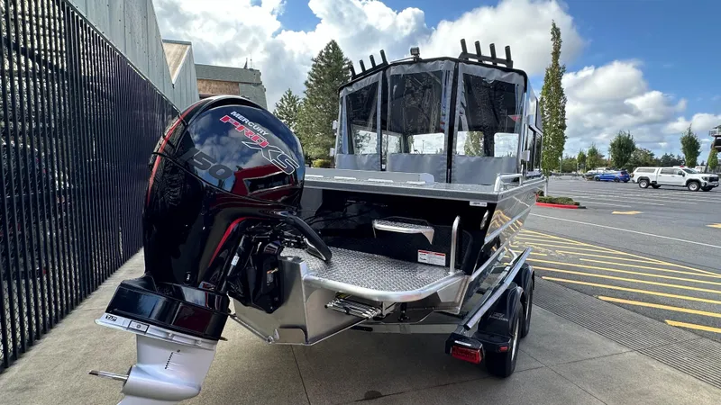 Slide: The Image of 2024 Spartan 184 ASTORIA boat with powerful outboard motor in a parking lot. - 6