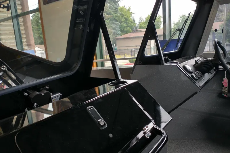 Slide: The Image of Interior view of 2024 Spartan 185 Astoria boat cockpit with steering wheel and controls. - 8