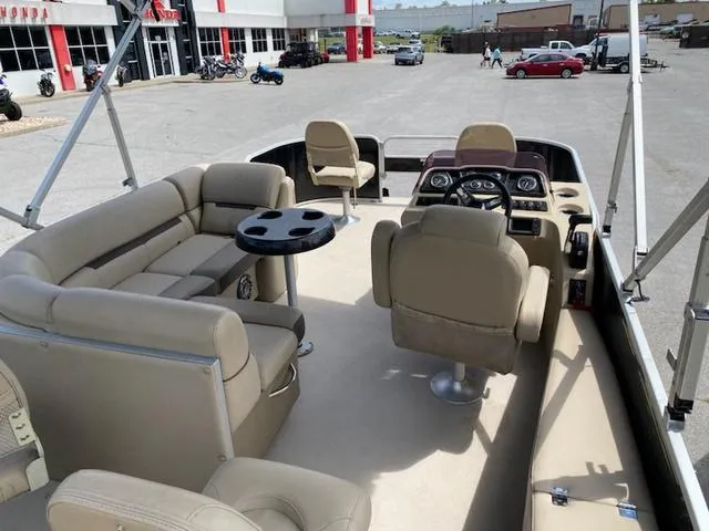 Slide: The Image of 2020 Godfrey SW2086F pontoon boat with beige seating and Sunrise Marine logo. - 5