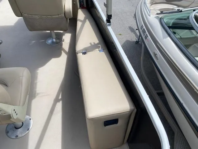 Slide: The Image of 2020 Godfrey SW2086F boat interior with beige seating and Sunrise Marine logo. - 8