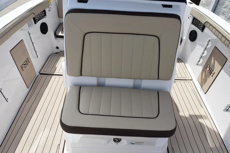 Slide: The Image of 2025 Yamaha Boats 222 FSH Sport E interior with beige seating and sleek design. - 11