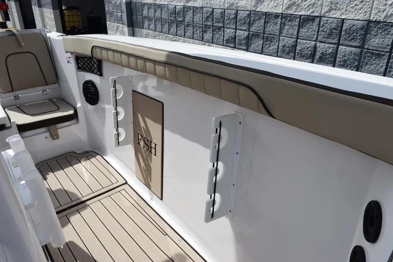 Slide: The Image of 2025 Yamaha Boats 222 FSH Sport E interior with seating and storage features. - 12