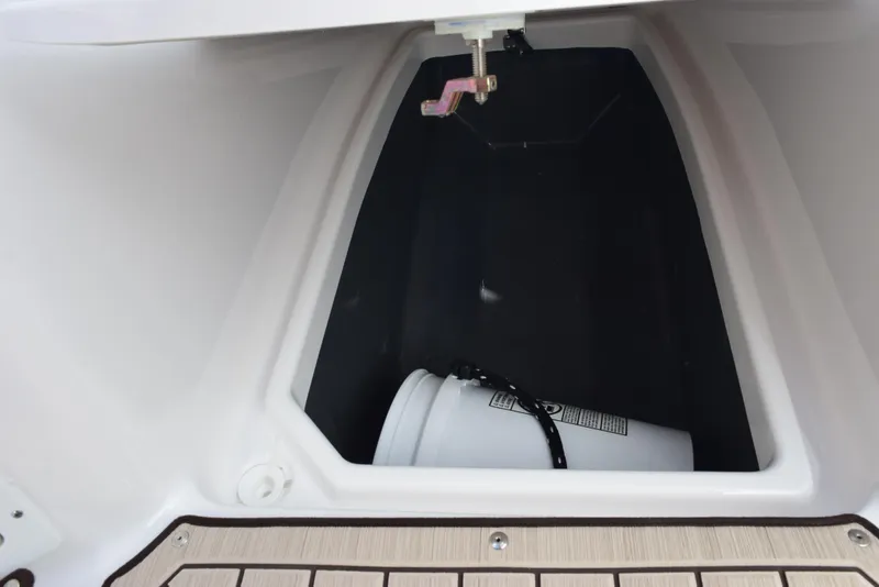 Slide: The Image of 2025 Yamaha Boats 222 FSH Sport E storage compartment with bucket. - 13