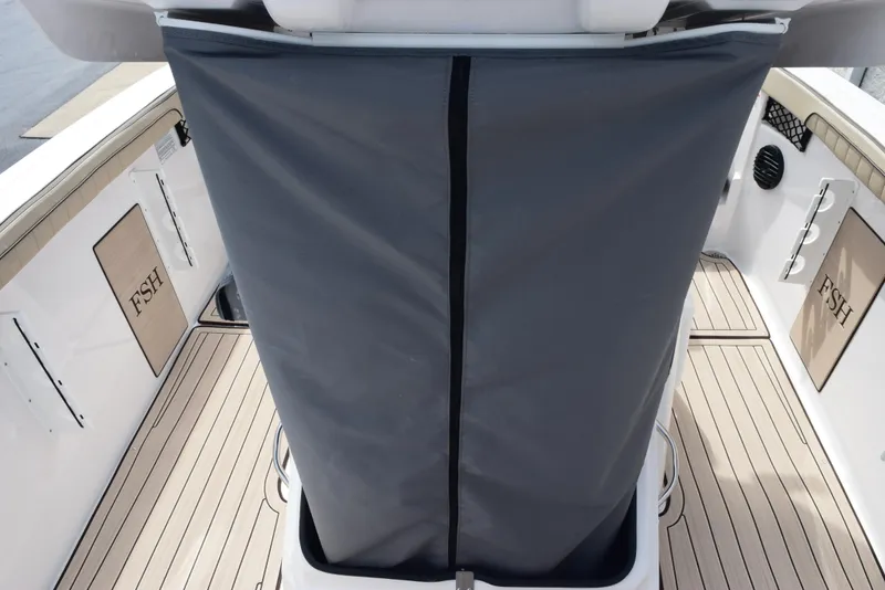 Slide: The Image of 2025 Yamaha Boats 222 FSH Sport E deck with protective cover, showcasing sleek design. - 14