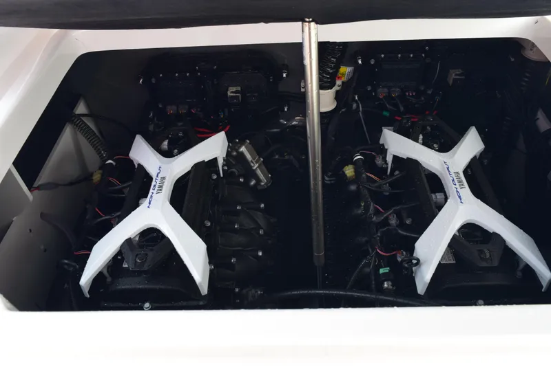 Slide: The Image of 2025 Yamaha Boats 222 FSH Sport E engine compartment with dual engines. - 19