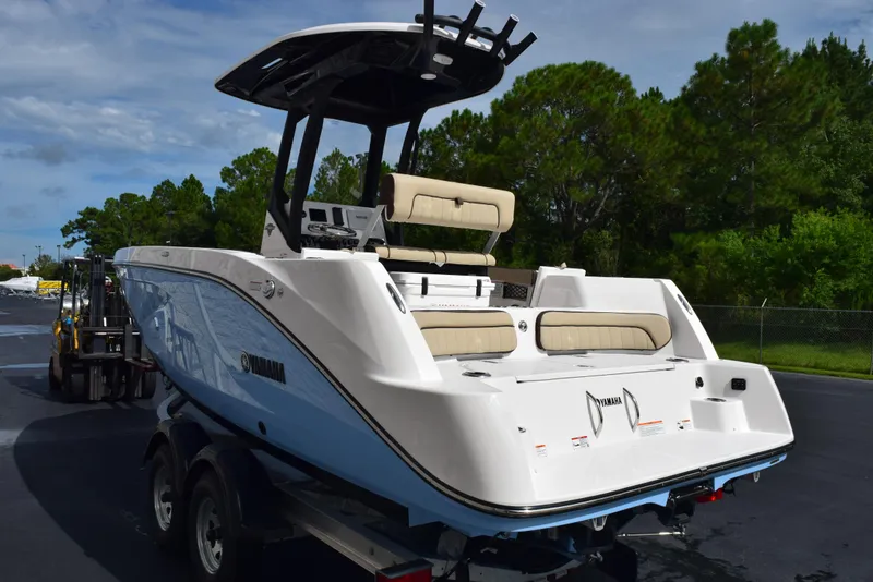 Slide: The Image of 2025 Yamaha Boats 222 FSH Sport E on trailer, sleek design, outdoor setting. - 5