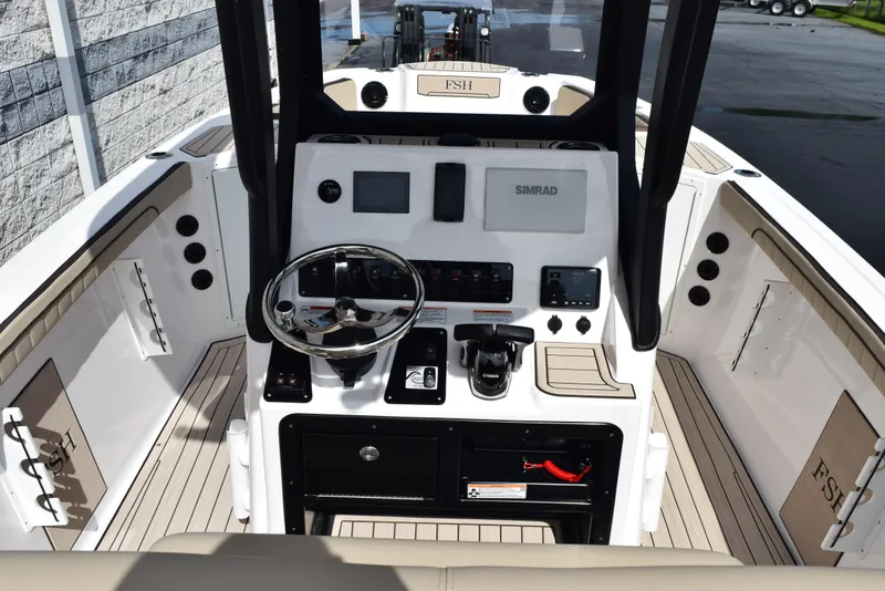 Slide: The Image of 2025 Yamaha Boats 222 FSH Sport E dashboard with steering wheel and controls. - 7