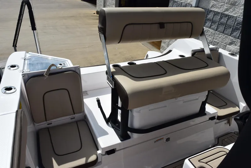Slide: The Image of 2025 Yamaha Boats 222 FSH Sport E interior seating with beige cushions. - 8