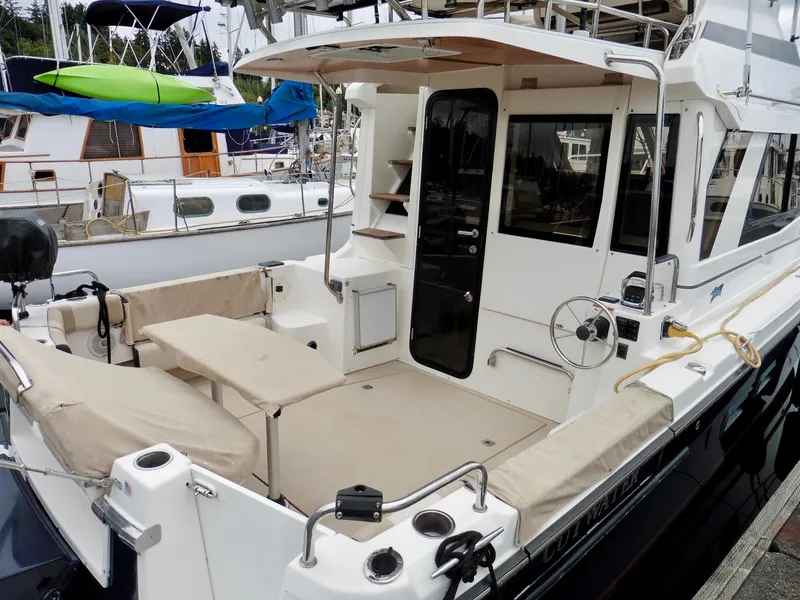 Slide: The Image of 2015 Cutwater 30CB boat with spacious deck and seating at marina. - 10