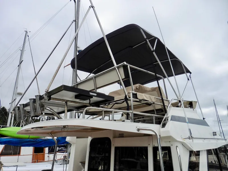 Slide: The Image of 2015 Cutwater 30CB boat with upper deck and canopy in marina. - 11