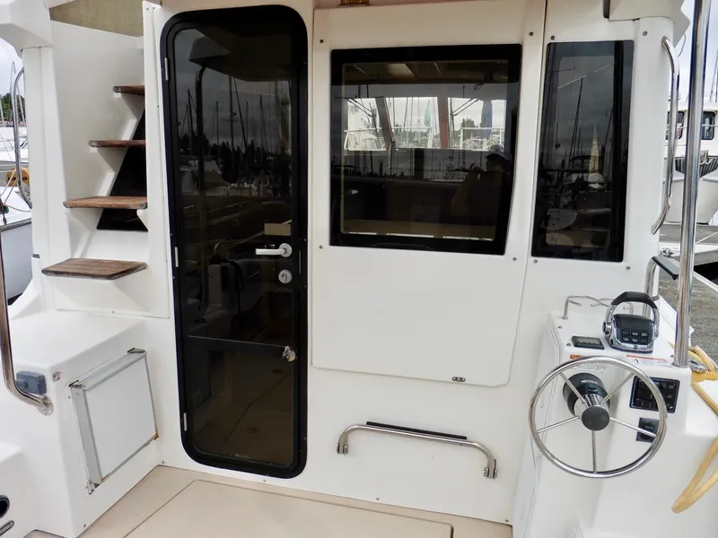 Slide: The Image of 2015 Cutwater 30CB boat cockpit with stairs, door, and steering wheel. - 17