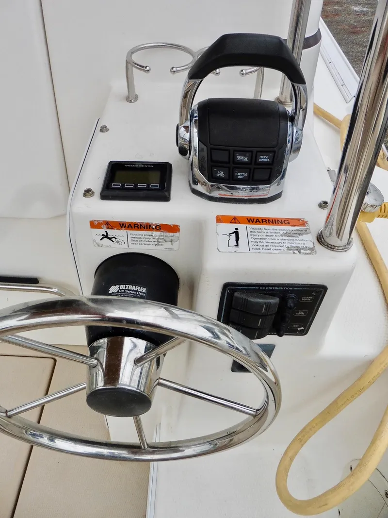 Slide: The Image of 2015 Cutwater 30CB boat helm with steering wheel and control panel. - 18