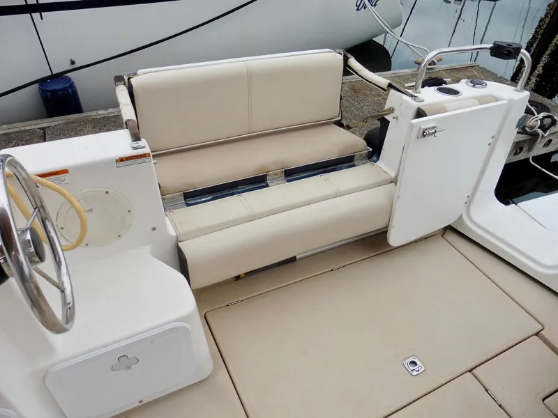 Slide: The Image of 2015 Cutwater 30CB boat interior with beige seating and steering wheel. - 20