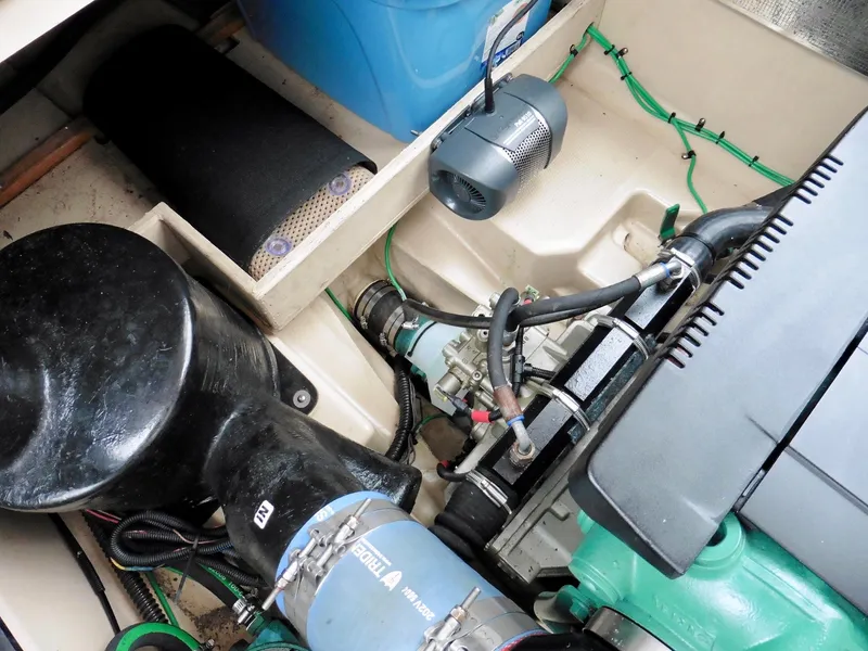 Slide: The Image of Engine compartment of a 2015 Cutwater 30CB boat, showcasing mechanical components and wiring. - 23